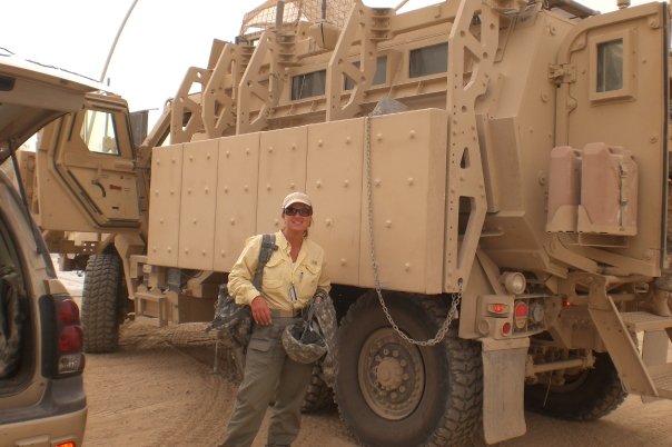 Dr. Tanya Lea standing next to an MRAP during military service